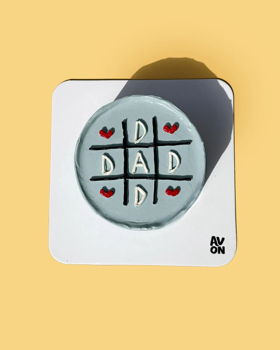 Dad Always Wins cake in light blue with DAD letters on a grid and red hearts