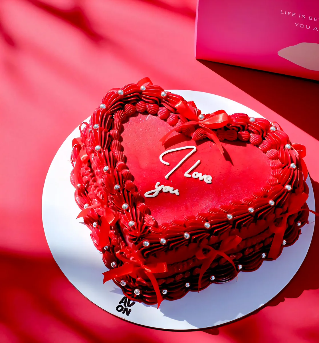 Red heart-shaped Heartbeat Cake with I love you, red bows and pearls