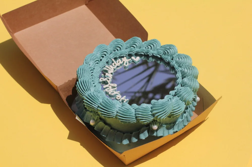 Mirror lunch box cake with a sky blue piped frame, pearls and Happy Birthday on the mirror