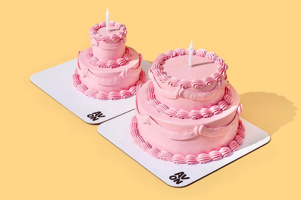 Pink mini two-tier cake for a newborn visit by Avon Cake
